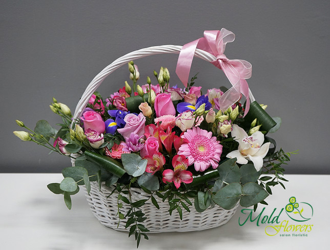Basket with pink roses, alstromeria, purple roses, chrysanthemum, eustomas, white orchids, gerberas photo